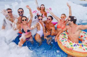 a group of people sitting in the foam on a raft at Temptation Cancun Resort - All Inclusive - Adults Only in Cancún