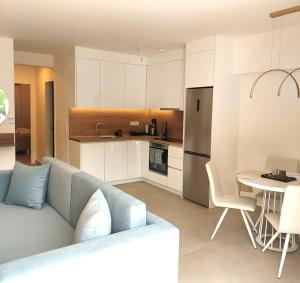 a living room and kitchen with a couch and a table at Athasi Resindences in Limenas