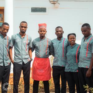 a group of men standing next to each other at The Nest in Kigali