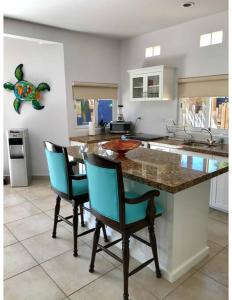3AP Beachy 1 bedroom 1 Bath Pool Lrg Patio في San Carlos: مطبخ مع كونتر وكرسيين ازرق