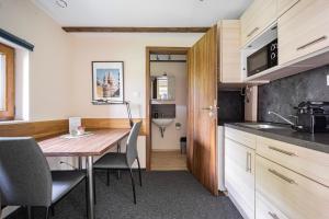 a kitchen and dining room with a table and chairs at B48 Gardenhouse - a zöldben kényelmesen in Törökbálint
