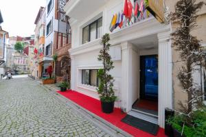 a red carpet in front of a building with a door at Loren Hotel&Suites in Istanbul