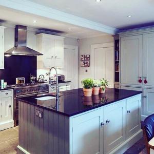 a kitchen with a black counter top with potted plants at Norfolk House Hosted by The Scarlet Hen in Huddersfield