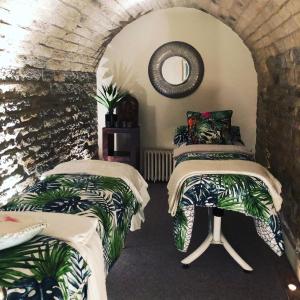 a room with two beds and a mirror at Norfolk House Hosted by The Scarlet Hen in Huddersfield