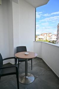 a table and chairs in a room with a window at MondurO Hotel in Durrës