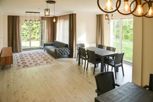 a living room with a table and chairs and a couch at Nora Marmara Luxury Villas in Istanbul in Istanbul