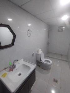 a white bathroom with a toilet and a sink at Waid Rum Jordan Jordan in Wadi Rum