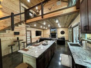 a kitchen and living room in a log cabin at The New Romantic Moonlight Dream Cabin! in Broken Bow