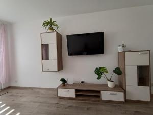a living room with a tv on a white wall at Madahar in Świnoujście