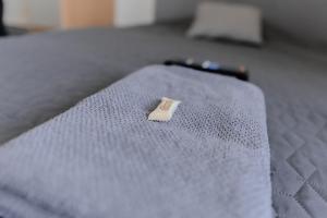 a tag on the end of a bed at Nordstay - Stylish Central Studio self check-in in Helsinki