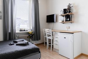 a bedroom with a bed and a desk and a window at Nordstay - Stylish Central Studio self check-in in Helsinki