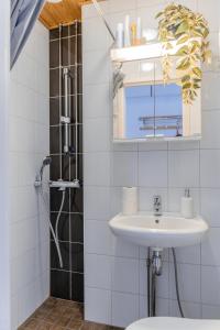 a bathroom with a sink and a shower at Nordstay - Stylish Central Studio self check-in in Helsinki