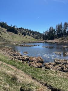 une rivière avec des rochers au milieu d'un champ dans l'établissement L'Anémone, à Ancelle