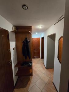 a hallway with a coat hanging on a door at Apartament Sosnowiec in Sosnowiec