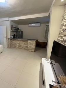a living room with a counter and a kitchen at Holiday house Karla in Vela Luka