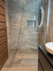 a bathroom with a glass shower with a sink at Superb 3 Bedroom Apartment in Gzira Promenade in Il-Gżira +10 photos