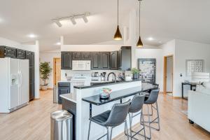 a kitchen with a counter and chairs in a room at Luxury Prairie Retreat 5 Min from Madison! in Sun Prairie