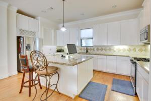 a kitchen with white cabinets and a table and chairs at Pet-Friendly Houston Home about 7 Mi to Downtown! in Houston