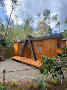 a wooden cabin with a black roof at Penginapan segitiga in Bandung