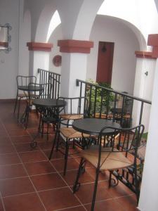 a group of tables and chairs in a room at Apartamentos Turisticos Casa Cantillo in Carmona