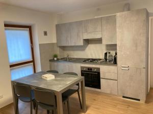 a kitchen with a table with chairs and a counter top at Casa Teresa in Germignaga