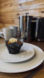 a white plate with a dessert on a table at Badger's Sett in Bathgate