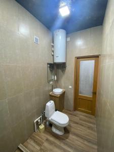 a bathroom with a white toilet and a sink at For the best in Sevan