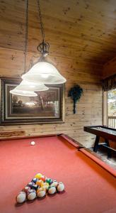 a room with a pool table and a chandelier at Beautiful 6 bdr cabin with hot tub in the Smokies! in Pigeon Forge
