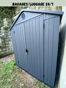 a blue garage door with a vent on top at Arina & Julien Dieppe in Dieppe