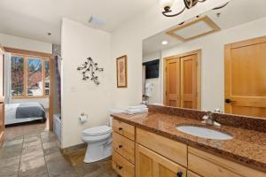 a bathroom with a toilet and a sink at Loft of Estes Park - Permit #6059 in Estes Park