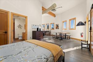 a bedroom with a bed and a dining room at Loft of Estes Park - Permit #6059 in Estes Park