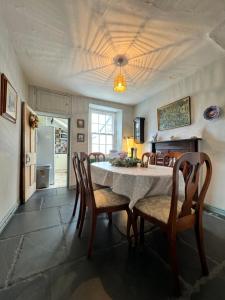 a dining room with a table and chairs at The Old Locksmith Cottage, Ulverston - Lake District in Ulverston