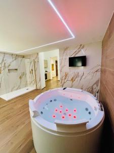 a jacuzzi tub in the middle of a room at Suite169 Gold in Bari