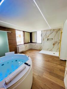 a bathroom with a jacuzzi tub in a room at Suite169 Gold in Bari