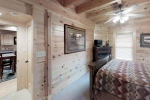 a bedroom with wooden walls and a bed in a room at Hideaway Haven in Waldens Creek