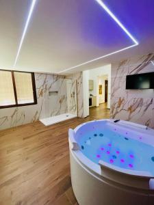 a large bathroom with a tub in a room at Suite169 Gold in Bari