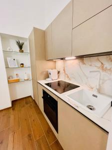 a kitchen with a sink and a counter top at Suite169 Gold in Bari