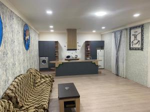 a living room with a couch and a kitchen at For the best in Sevan