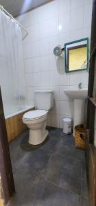 a bathroom with a toilet and a sink at Turismo Rural Lo Vilches in Chillán
