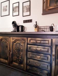 a kitchen with a wooden cabinet with a counter top at Gold Apartament in Wałbrzych