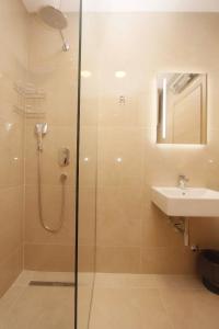 a bathroom with a shower and a sink at Apartman Ruzmarin in Budva