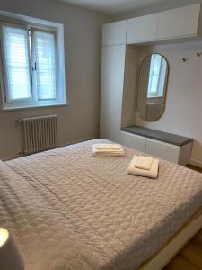 una camera con un grande letto e uno specchio di Appartamento Scaligeri a Venzone
