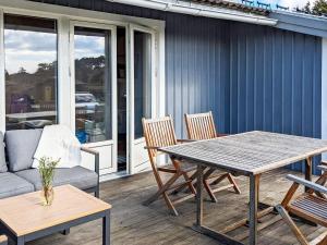 a patio with a table and chairs and a couch at Holiday home ELLÖS II in Ellös