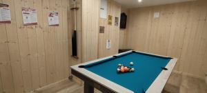 a pool table in a room with three balls on it at Chalet 360 l Essenti Aile, Gerardmer La Mauselaine in Gérardmer