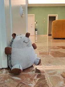 a teddy bear sitting on the floor in a room at La Corticella in Lucca