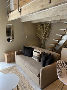 ein Wohnzimmer mit Sofa und Treppe in der Unterkunft Appartements St. Pancrace in Corte