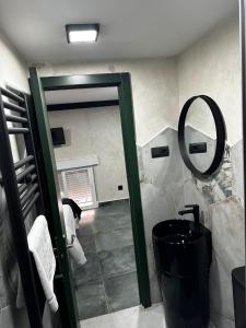 a bathroom with a mirror and a black tub at T-Homes - Cuenca in Madrid