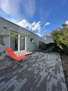 a patio with two chairs and an umbrella at Zielona Góra Apartament in Jugów