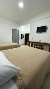 a large bed in a room with a flat screen tv at Hotel Santa Fe in Tuxtla Gutiérrez