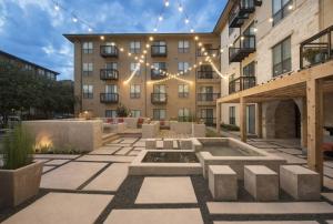 a large building with a courtyard with a fountain at Luxury Condo-Style Hotel In Domain Shopping Center in Austin